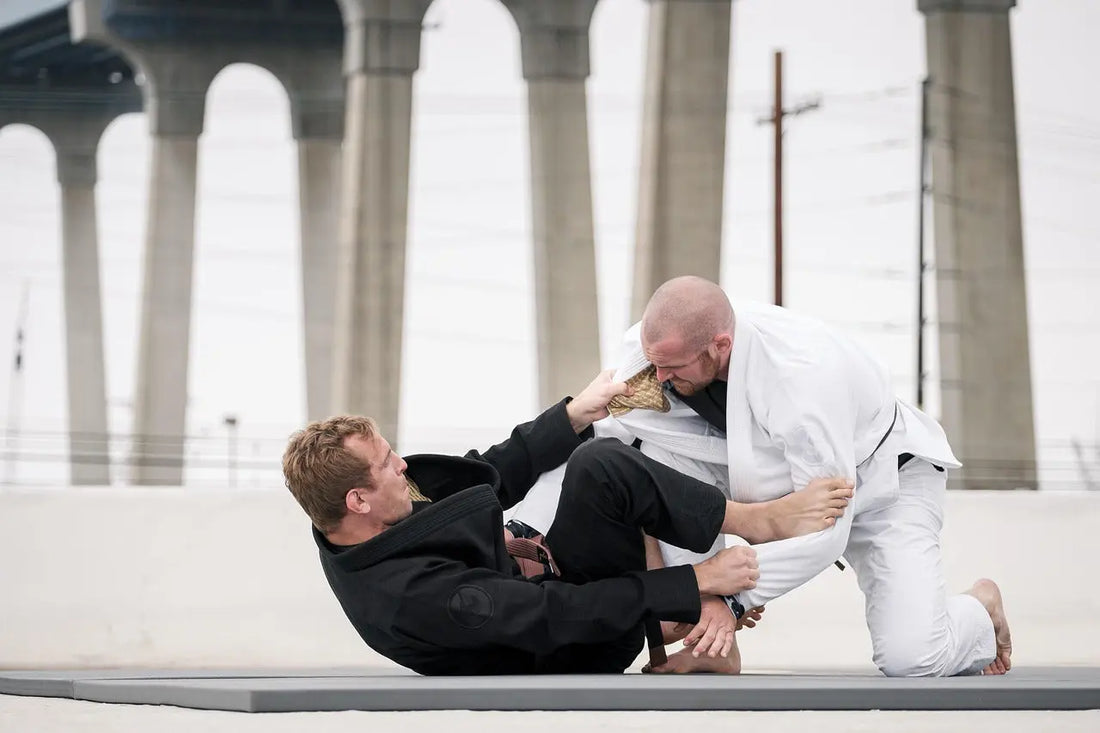 Brazilian Jiu-Jitsu athletes fighting for grips during a match.